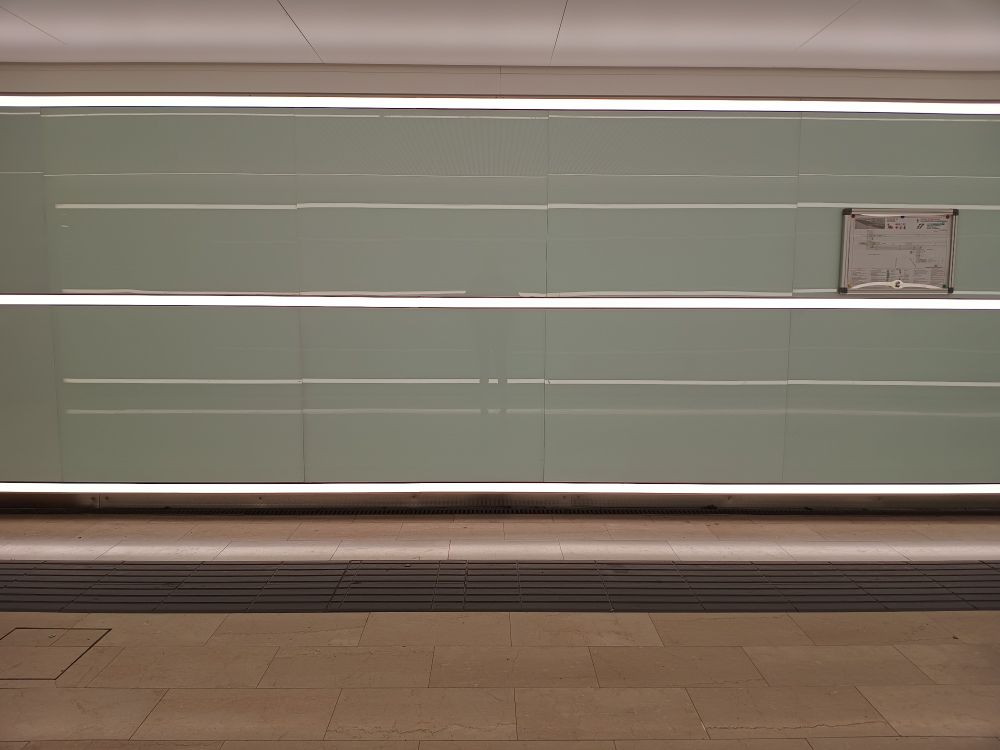 A picture taken in the underpass of Roma Ostiense station showing a game of lights on a mirror-like surface and creating a series of lights stripes