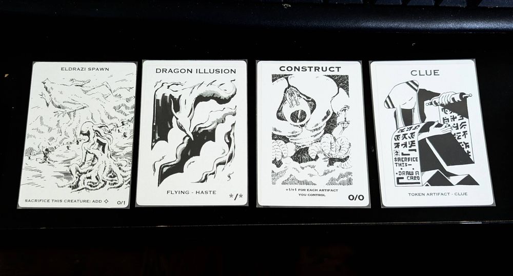 From left to right, a Eldrazi Spawn, Dragon Illusion, Construct and Clue token.