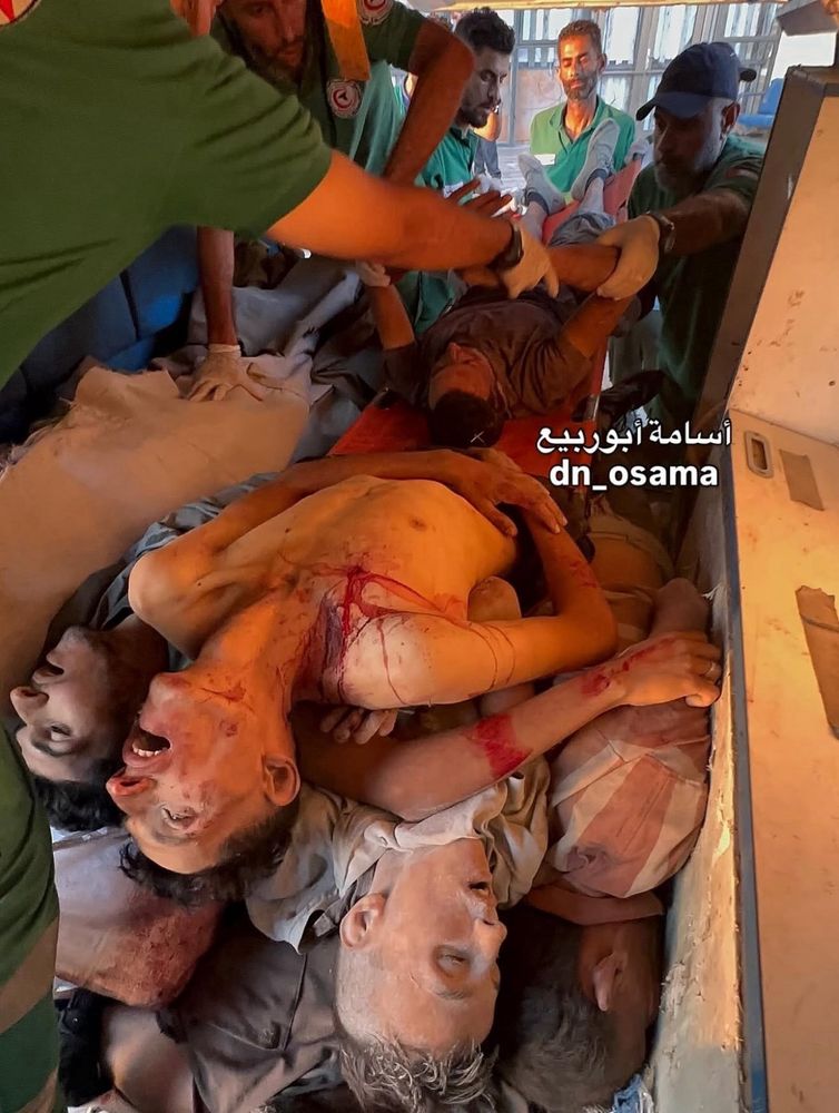 Emaciated bodies stacked like firewood inside an ambulance.