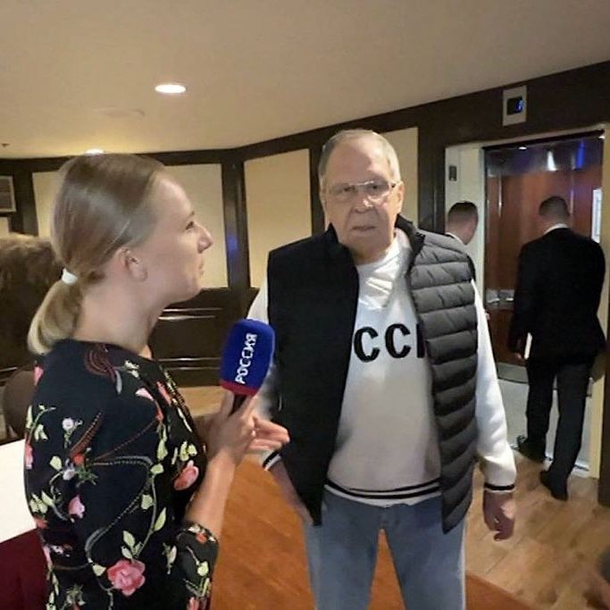 Lavrov wearing a gray CCCP sweater and black vest.