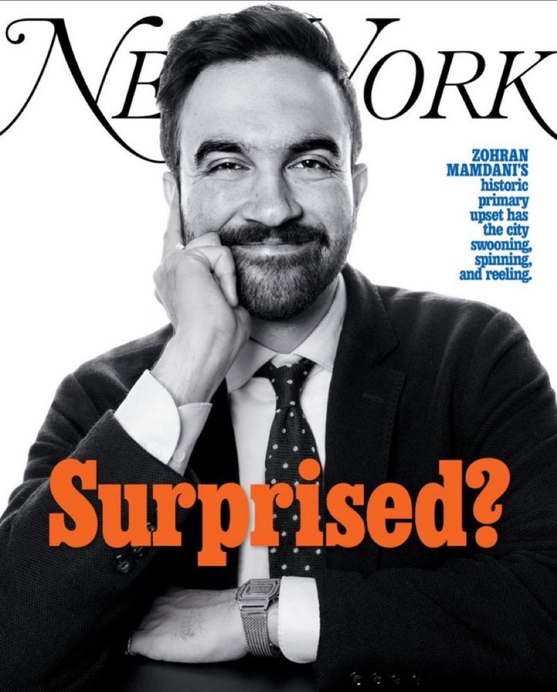 New York magazine cover with a black and white photo of Zohran Mamdani propping his face on his hand and smiling with an orange caption “Surprised?”