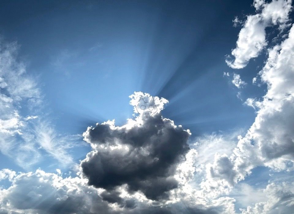 A photo of clouds with shafts of light emitting from behind a dark cloud. Not very good at describing. My 📷