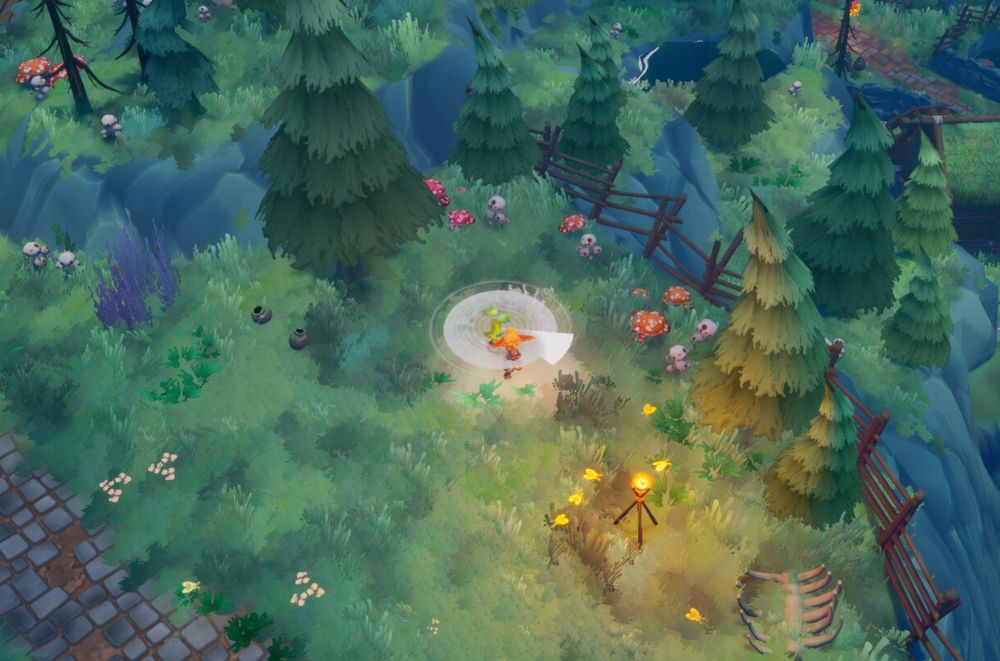 Rekindled Trails. Un personnage vu à l'isométrique cueille une plante dans une petite forêt en bordure d'une route pavée.