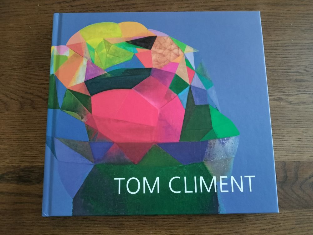 Cover of Tom Clement art book. Multicolour abstract shape on blue background.