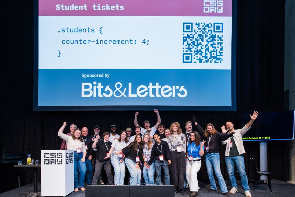 Student participants posing on the conference stage at CSS Day 2025