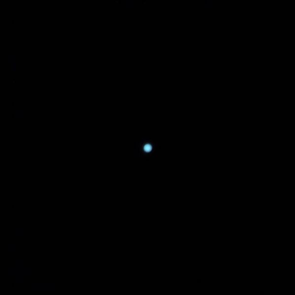 Properly exposed image of the planet Uranus, seen as a very small, pale belt disc.