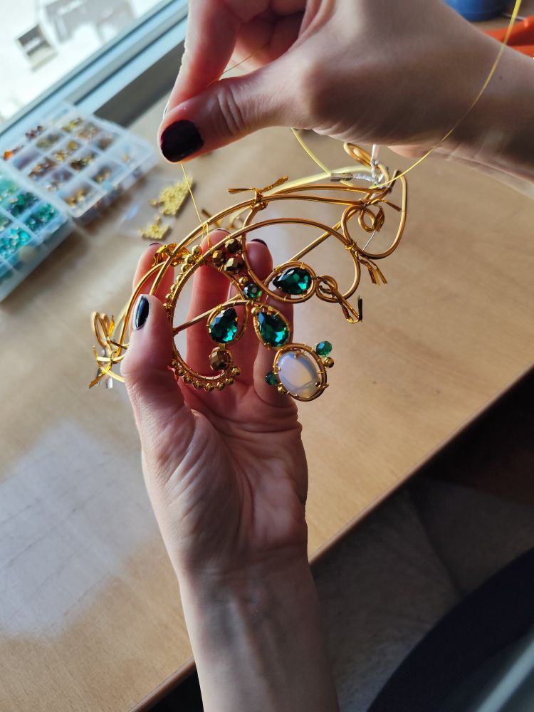 Custom Olasse circlet on the works. My customer preferred it to be gold wires with hints of teal and opalites.
The original piece is completely silver, for a very elegant, simple look.