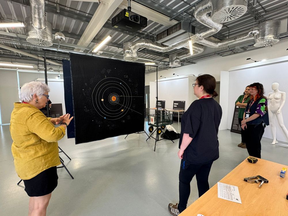 RAS staff help set up the RAS Bicentennial Quilt and its Solar System companion piece (pictured).