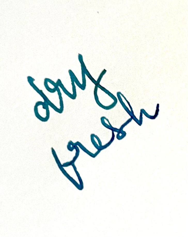 two words wrtitren in cursive on unlined white paper. The top word says "dry" and is a soft blue-green, while the bottom word says "fresh" and is noticeably more blue.