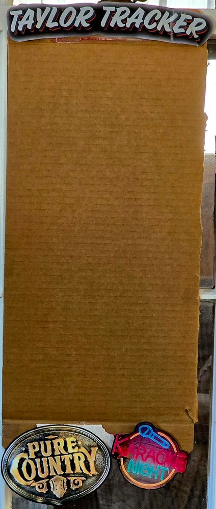 Cardboard piece with "Taylor Tracker" across the top, the Pure Country movie logo, and a sign that says "Karaoke Night" on the bottom. 