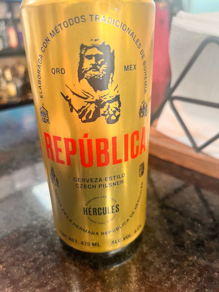 A golden can with lion pelted Hercules emblazoned in black
REPUBLIC stamped in furious red 