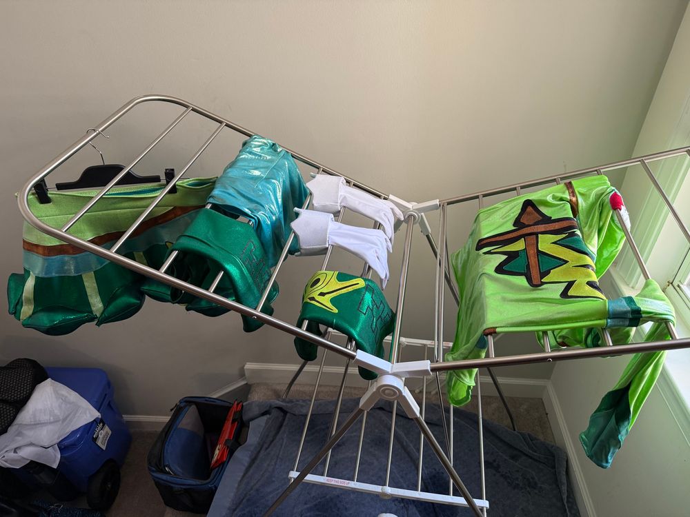 Grass Trainer Hatsune Miku cosplay and Mirko gloves on a drying rack.