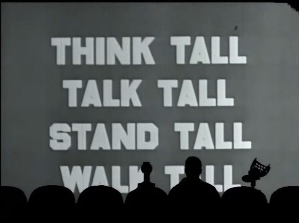 Giant words on screen before the MST3K silhouette. The words shout, think tall, talk tall, stand tall, walk tall.