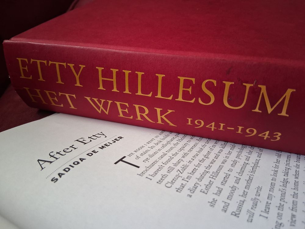 Etty Hillesum's thick book (dark red cloth cover with gold letters: ETTY HILLESUM HET WERK 1941-1943) lies on The New Quarterly, which is opened to my essay After Etty.