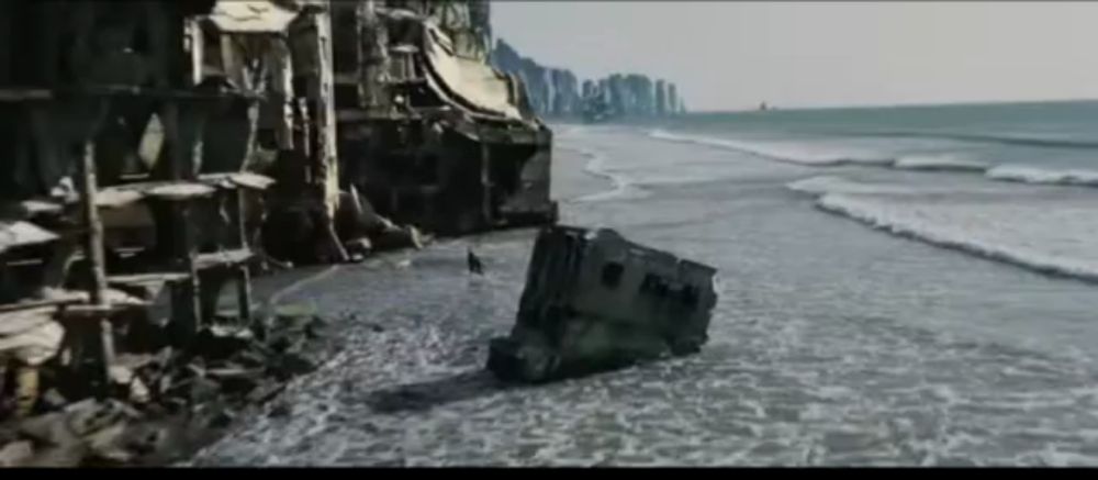 a shipwreck sits on the shore of a beach