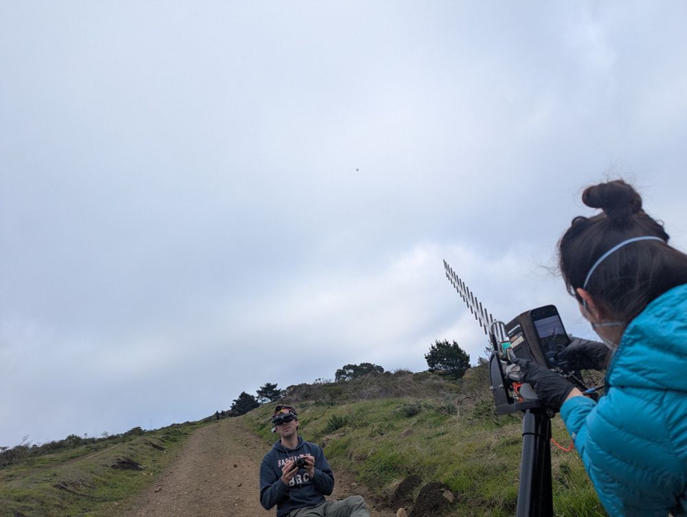Aiming the groundstation's directional antenna to maintain a strong signal while another teammate chases with a FPV drone.