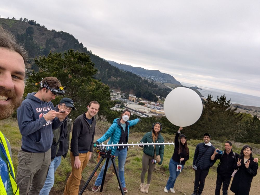 Spacebridge team posing with the balloon in front of an overlook of Pacifica immediately before launch.