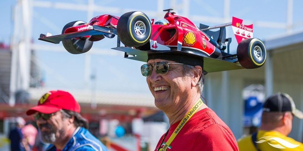 Guy with a replica F1 car built into his hat.