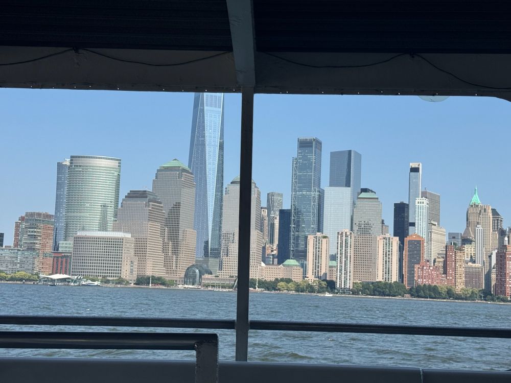 the lower Manhattan skyline seen from the upper deck of a NY Waterways ferry, traveling from Battery Park to Hoboken