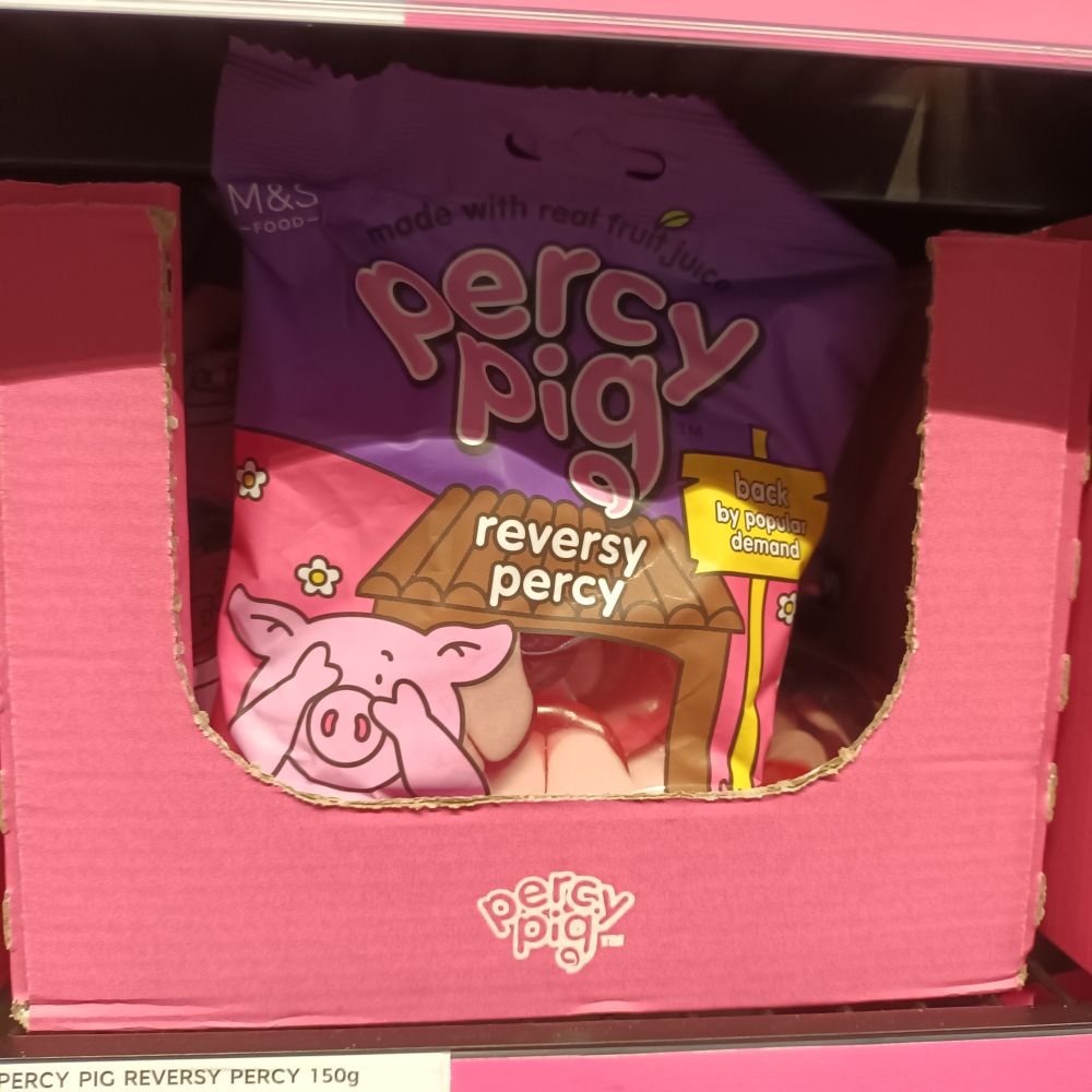 A packet of M&S Percy Pig "reversy percy" sweets in a shop.  The packet shows a pig covering its eyes in embarrassment, and one of the pig sweets in the packet appears to be mooning the viewer.   Quite disgraceful. 