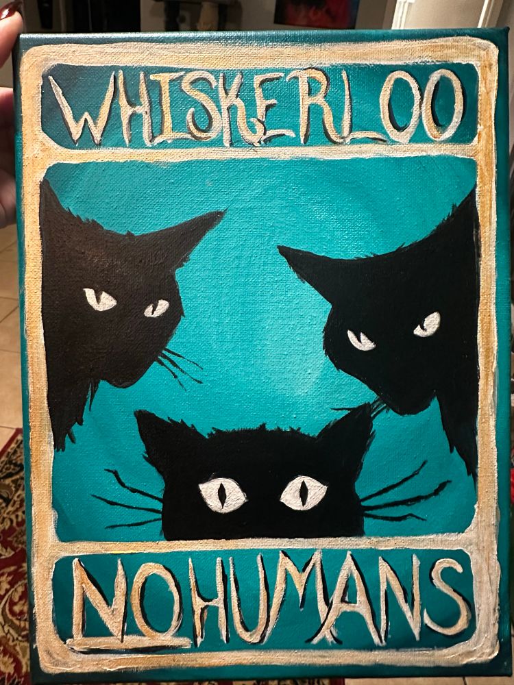 Painting of a sign done by fetal Goth of three black cats, silhouette against a green background and a gold border it whiskerloo no humans