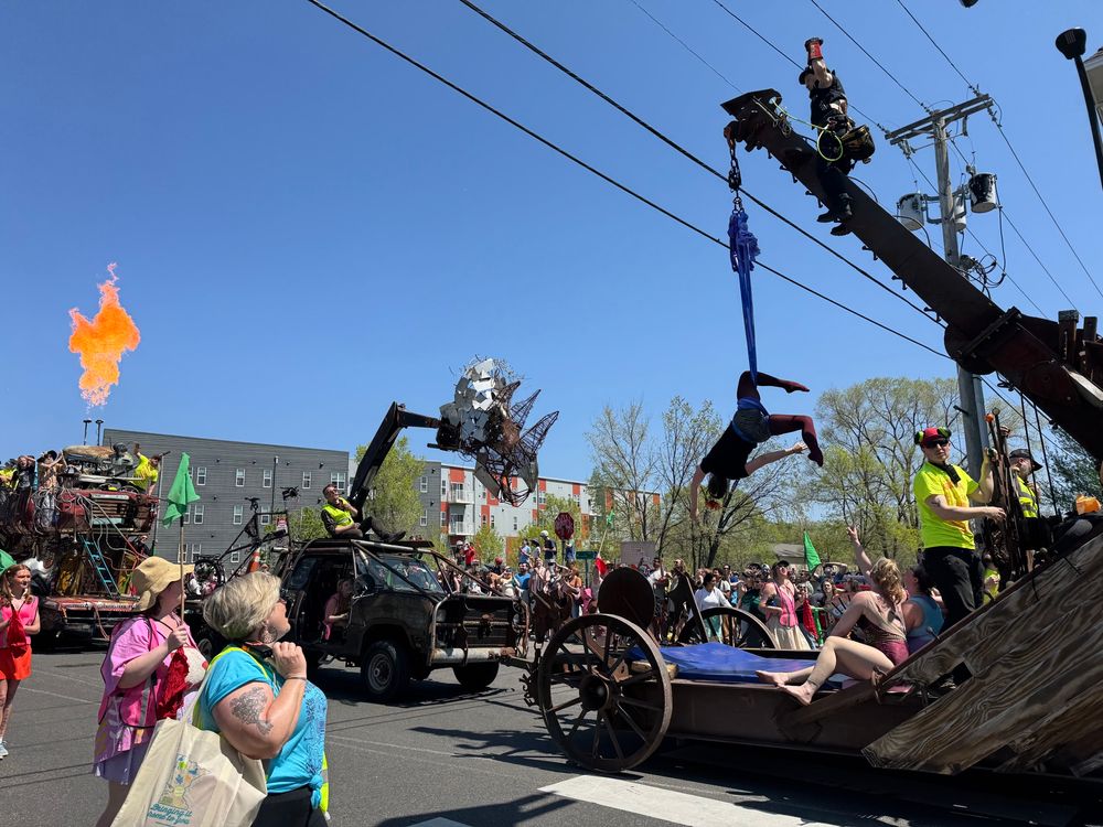 More “battle train” with an upside-down acrobatic, a triceratops sculpture truck, and flames shooting from another float further back.”