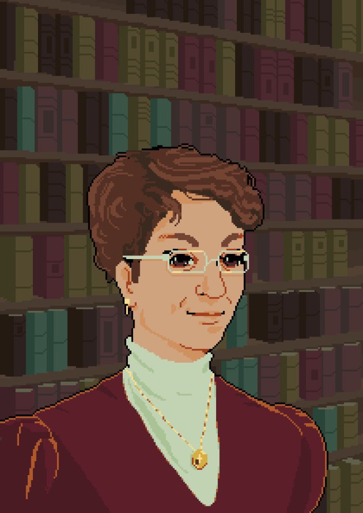 A woman with short brown hair and glasses standing in front of a wall of books. She is wearing a maroon dress with a white lace collar.