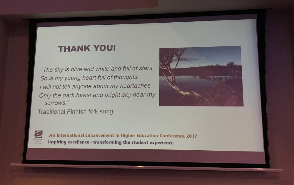 A photo of a projector screen showing a slide that reads:

'THANK YOU!

"The sky is blue and white and full of stars.
So is my young heart full of thoughts.
I will not tell anyone about my heartaches.
Only the dark forest and bright sky hear my sorrows."

Traditional Finnish folk song'
