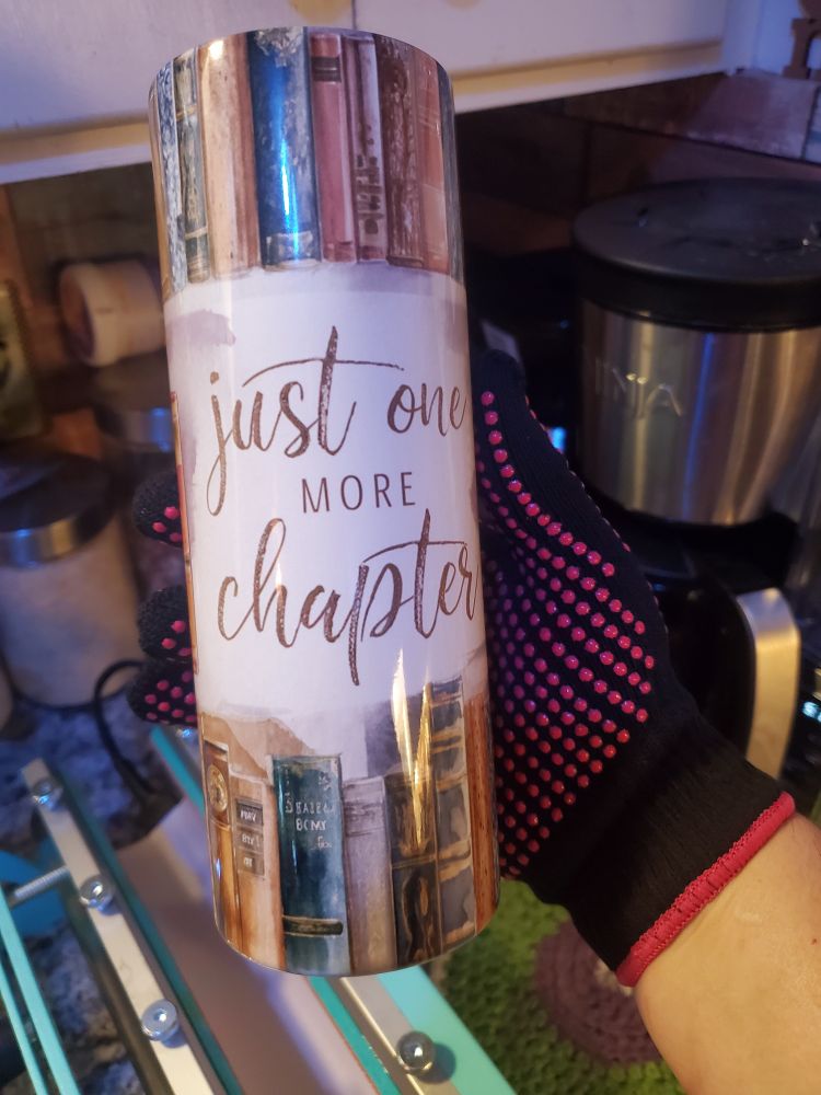 Coffee Tumbler with "Just one more chapter" image sublimated on the cup.