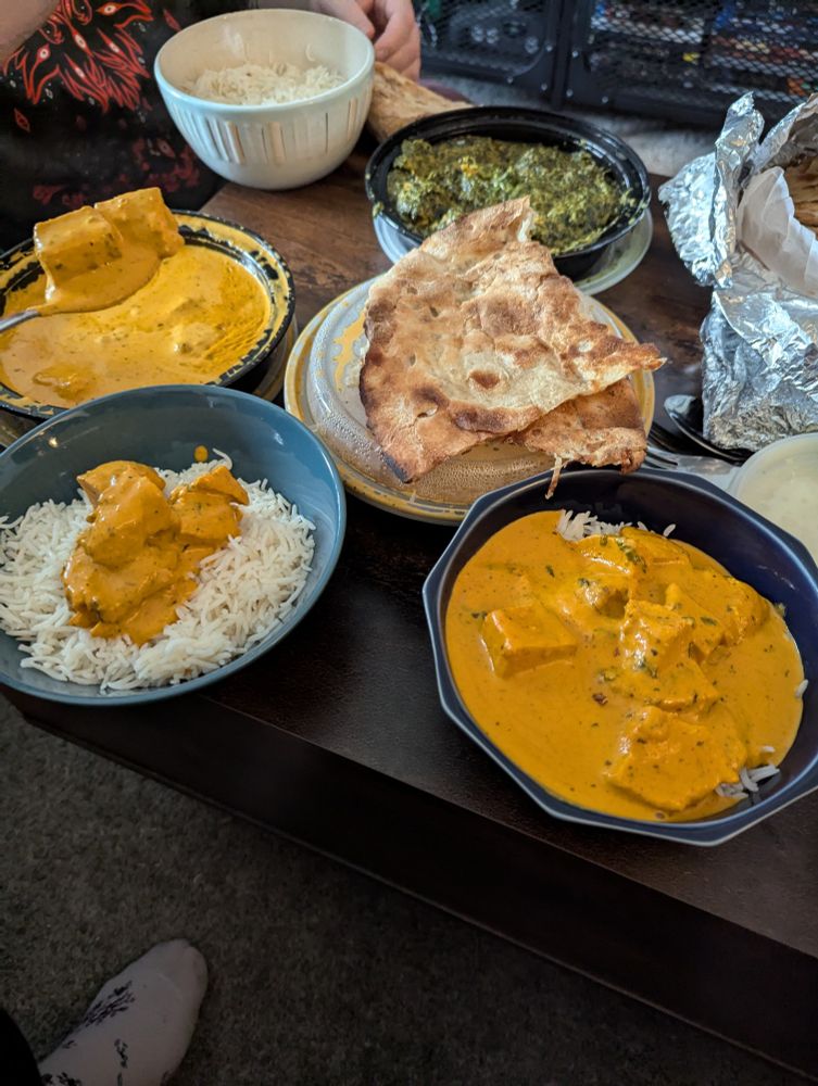 A lunch spread of chicken Tikka and cheese naan