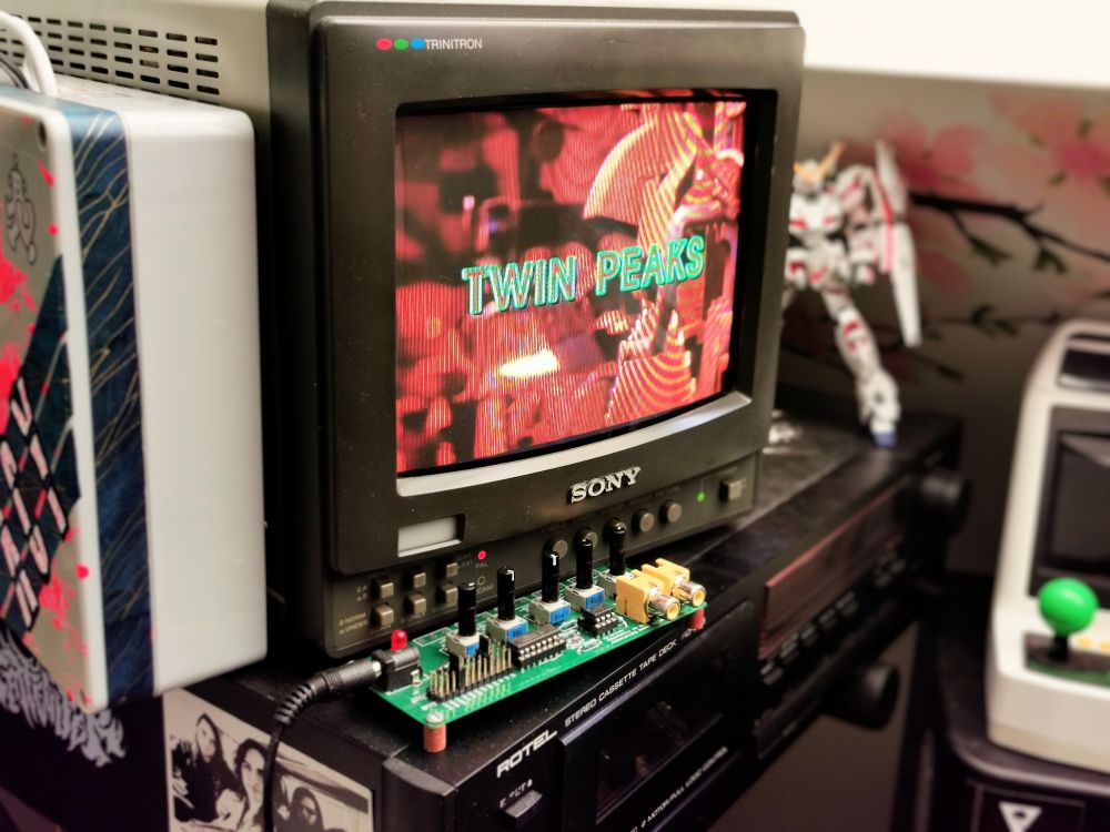 A small CRT monitor, showing the intro credits to Twin Peaks