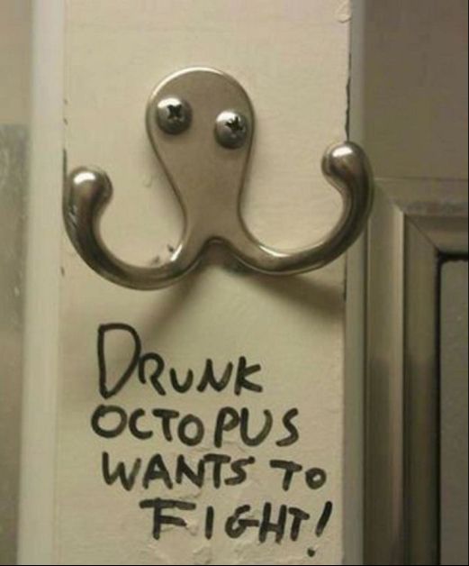 A two-curved-pronged coat hook on the back of a door, inset with two screws at slightly different heights to each other, with the words "DRUNK OCTOPUS WANTS TO FIGHT" underneath - which is exactly what it looks like.