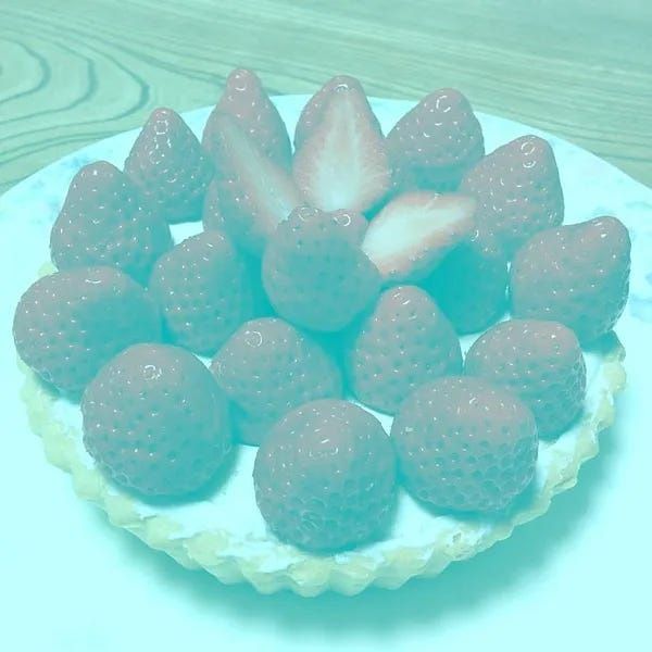 Green-tinted image showing a bowl of strawberries created by Japanese psychologist Akiyoshi Kitaoka that doesn’t have any red pixels in it, despite the strawberries looking red (they're actually grey, and it's just their relation to the overall green tint combined with what colour we expect to see on a strawberry that creates the illusion). 