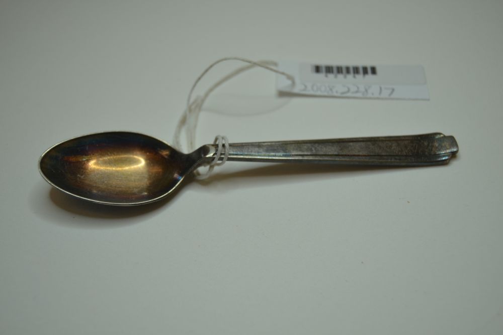 Spoon, silver, taken by Holocaust survivor from the Warsaw Ghetto when she escaped from there (top view).