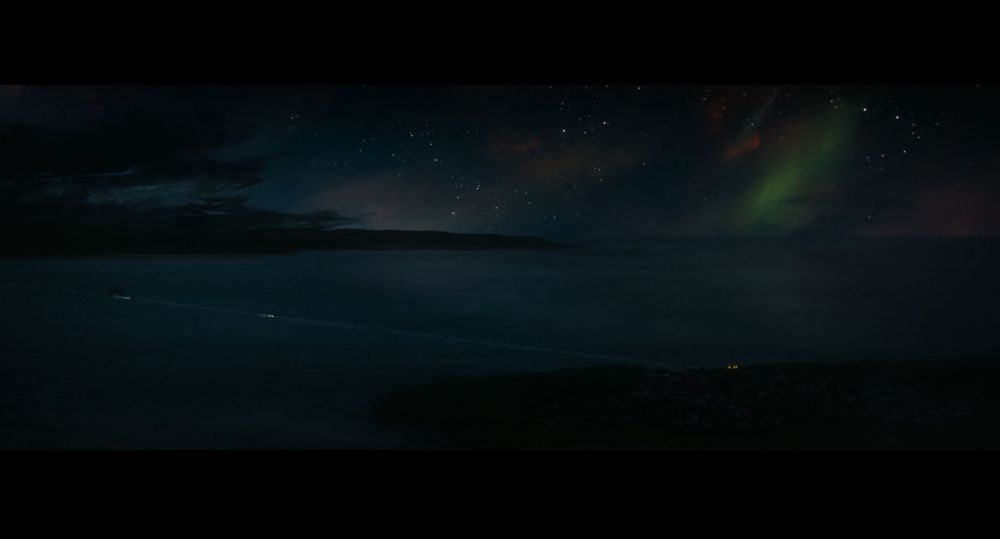 a screenshot from Danny Boyle's 28 Years Later.. the long dark causeway with northern lights in the sky