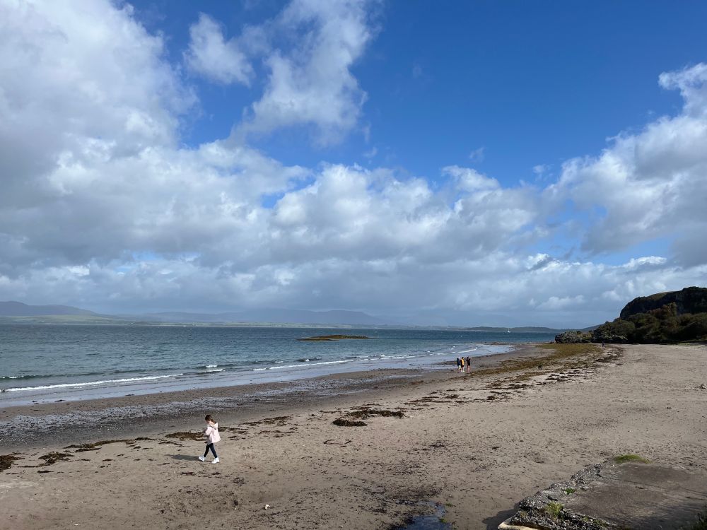 Ganavan sands beach. It’s is beach reaching into the sea and it is overcast 