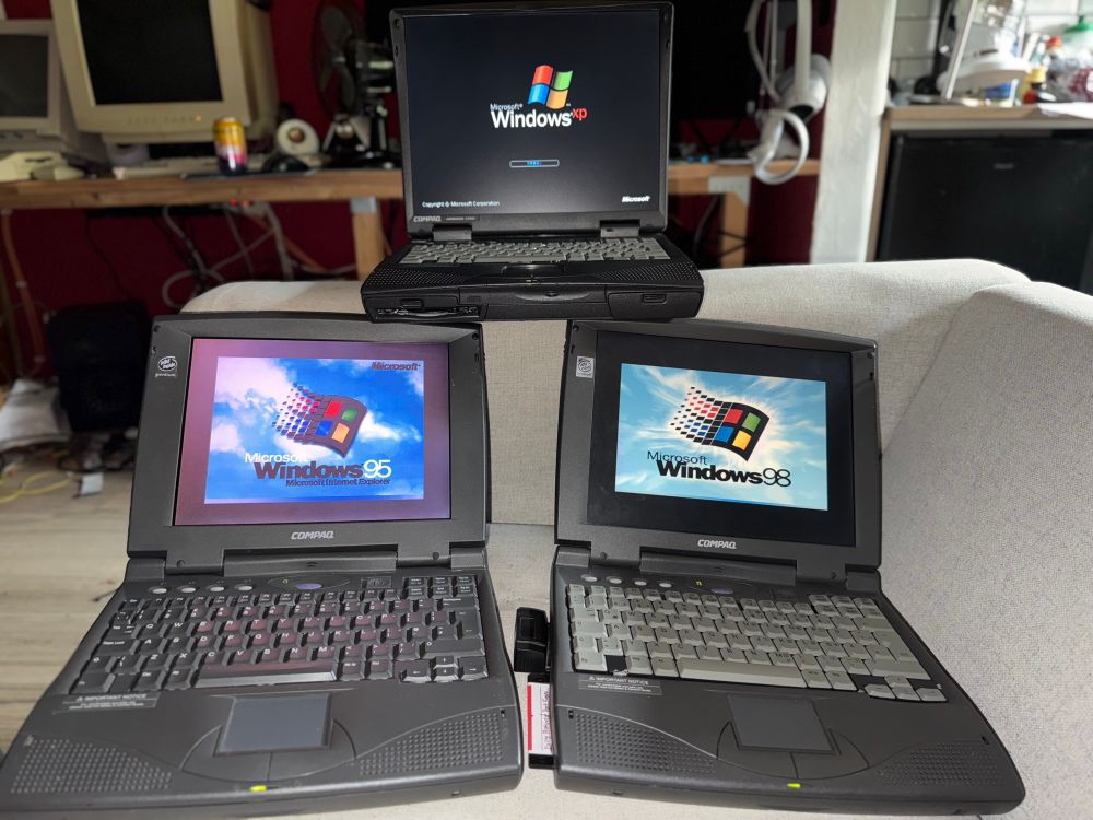 Compaq Armada 1520D (bottom left), -1590DMT (bottom right), and 1750 (top), booting into their respective operating system. (Windows 95 for the 1520, 98 for the 1590, XP for the 1750)