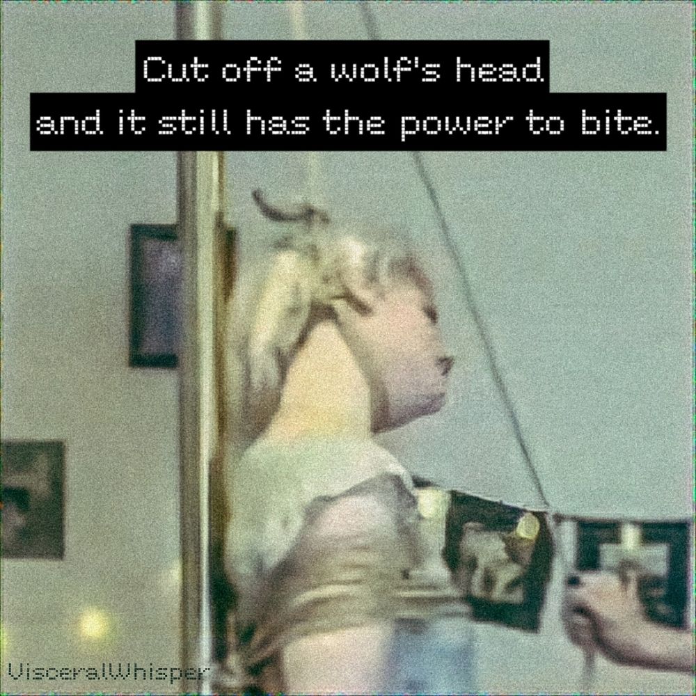 An adult woman with a rope around her neck looking at the person holding tension on the rope.  Across the top is a quote from the movie Princess Mononoke  "Cut off a wolf's head and it still has the power to bite". This image intends to provoke feelings of strength and perseverance in situations where one might feel vulnerable or defeated.