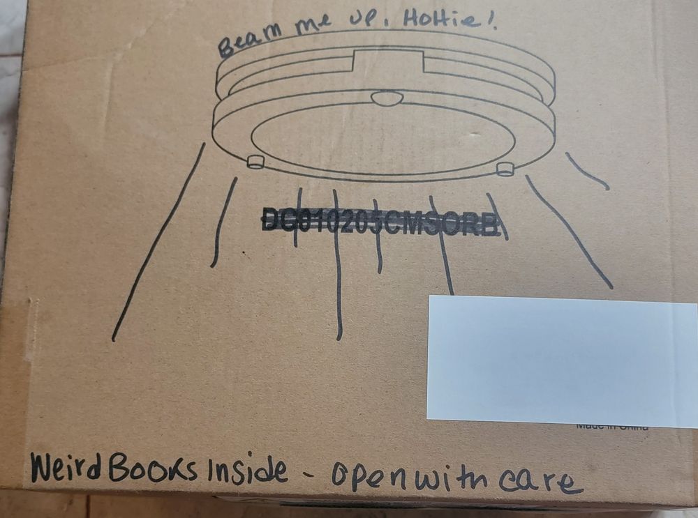 Box that says Beam me up, Hottie over a drawing of a possible UFO. Weird books inside-open with care on the bottom.  