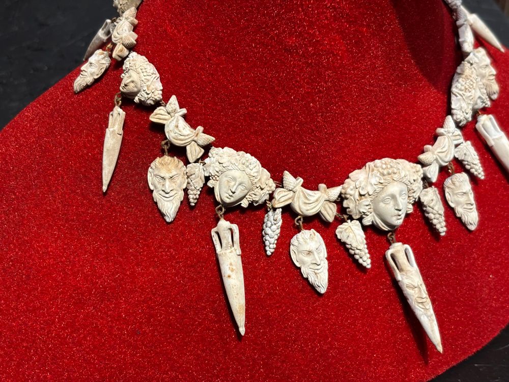 Closeup of a necklace on a red stand, displayed at the Frankenstein exhibition in London