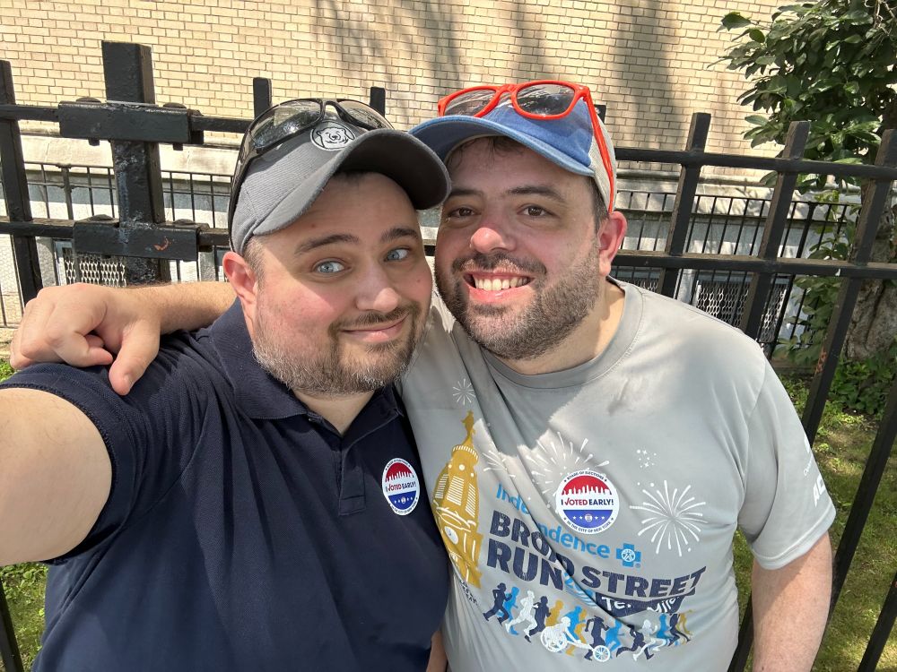 Patrick and Scott celebrating after early voting, wearing "I Voted Early!" stickers.