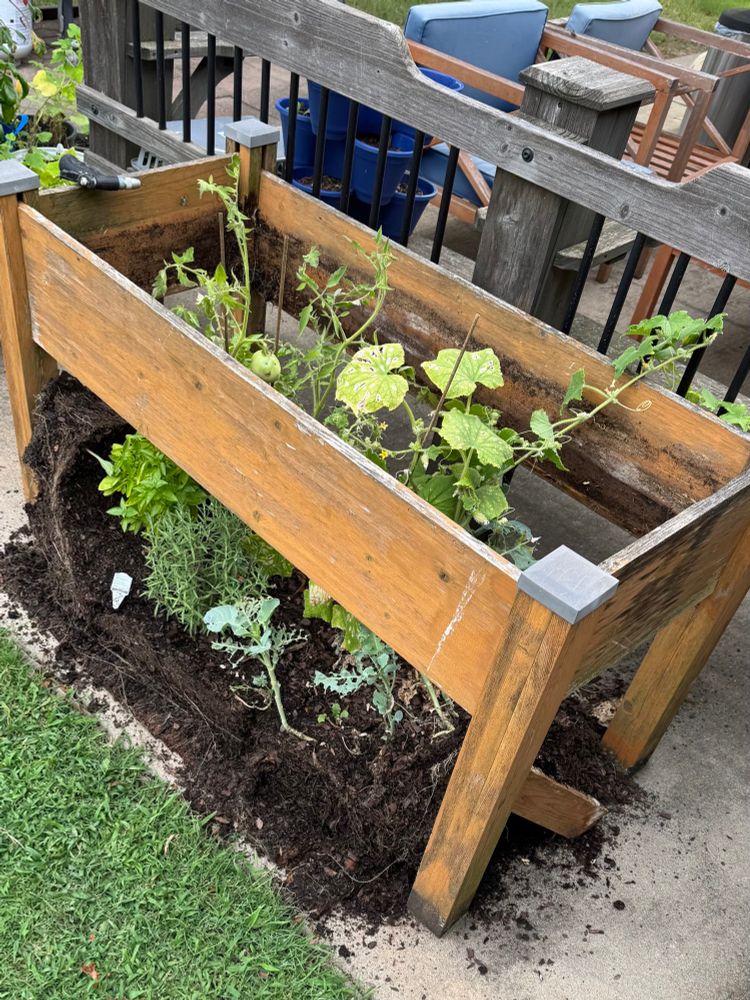 A raised garden bed with the bottom falling out onto the floor