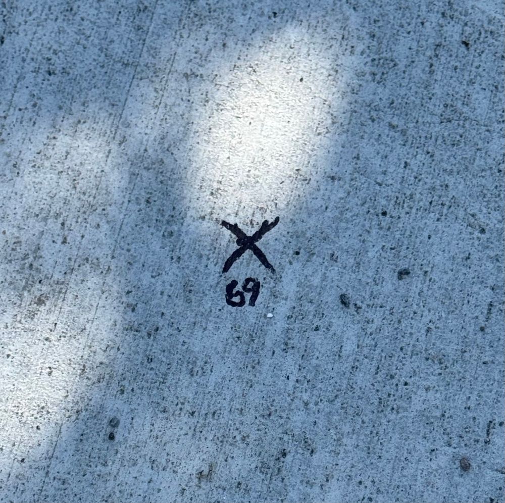 69 written on the sidewalk 