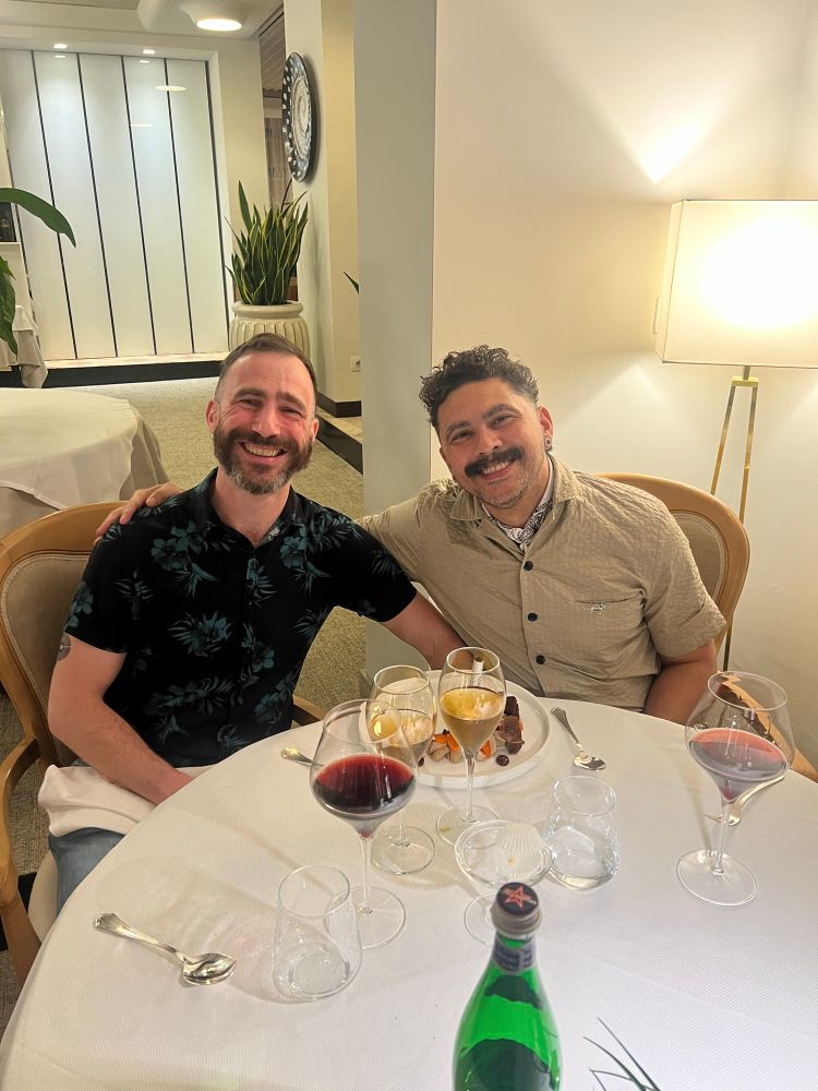 Julien and Nivas in a nice restaurant, with sweet wine and dessert.