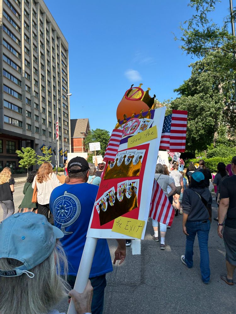 A crown on an orange balloon with a banner symbol on it. 