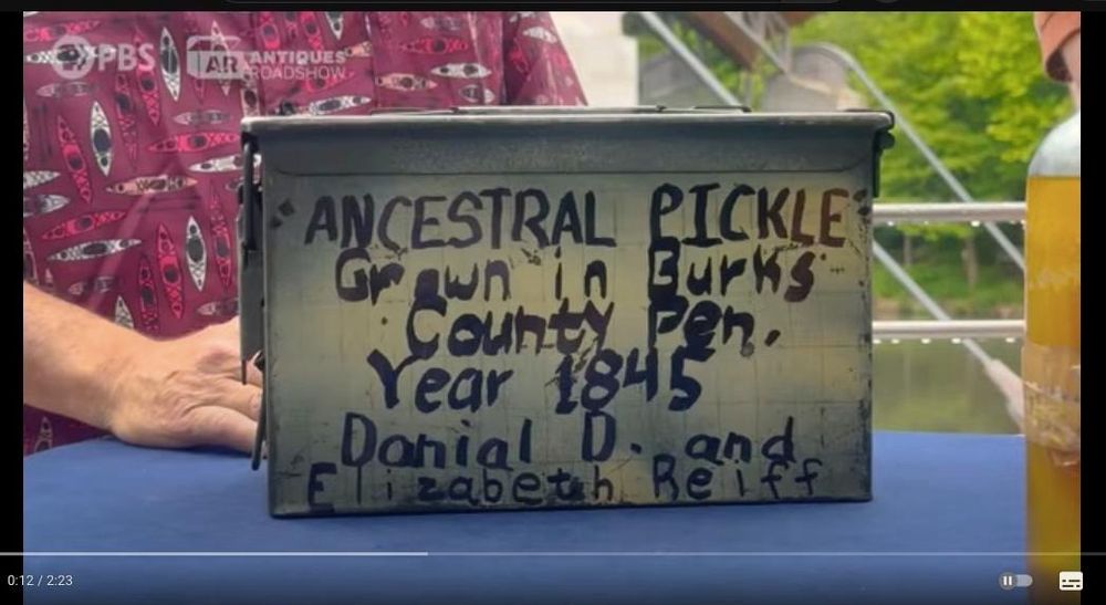 A screenshot from Antiques Roadshow, an ammo box with scrawled text: ancestral pickle 1845