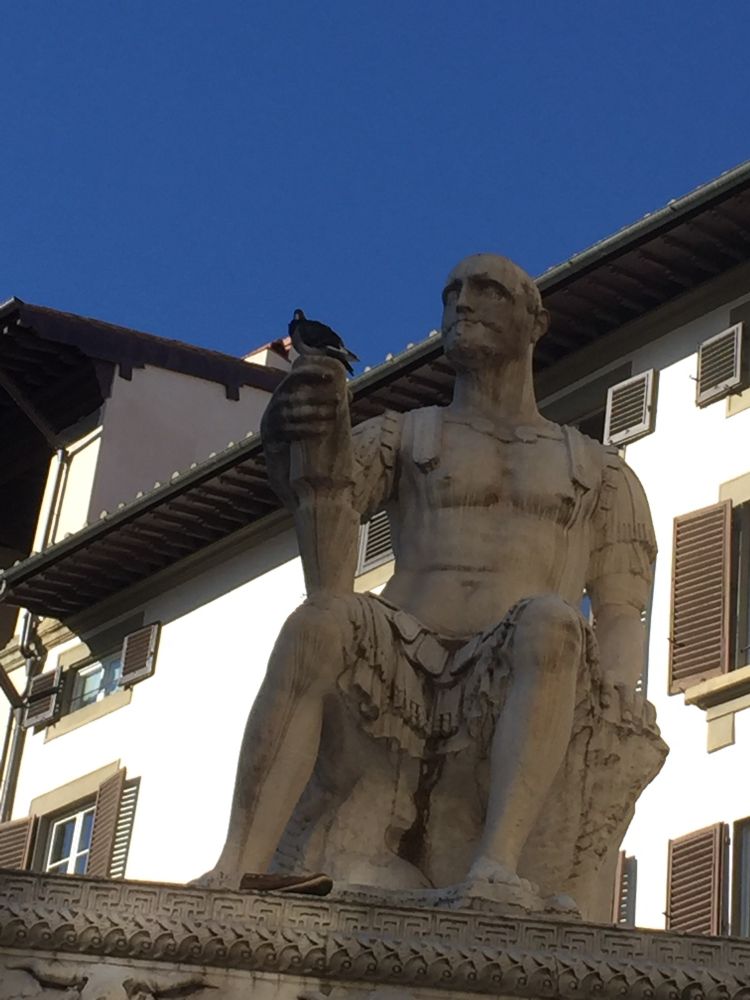 Ancient Roman statue w/ pigeon sitting on his hand 