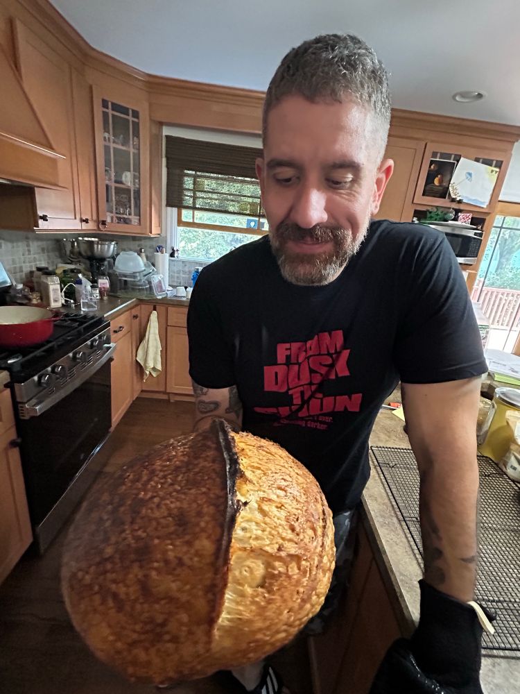 Me stating longingly at a freshly-bakes boule of sourdough.