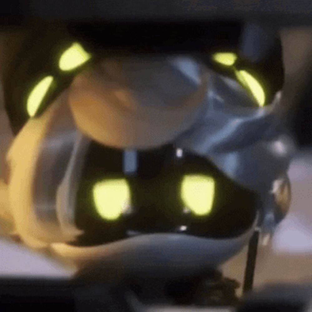 a close up of a cartoon character with glowing eyes sitting on a table .