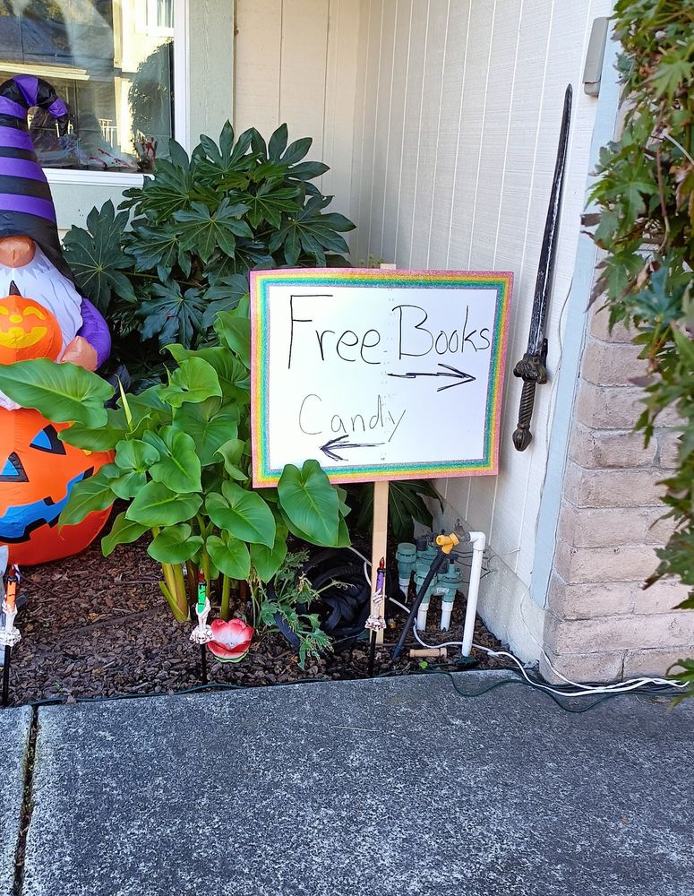 Rainbow sign that points to free books or candy 